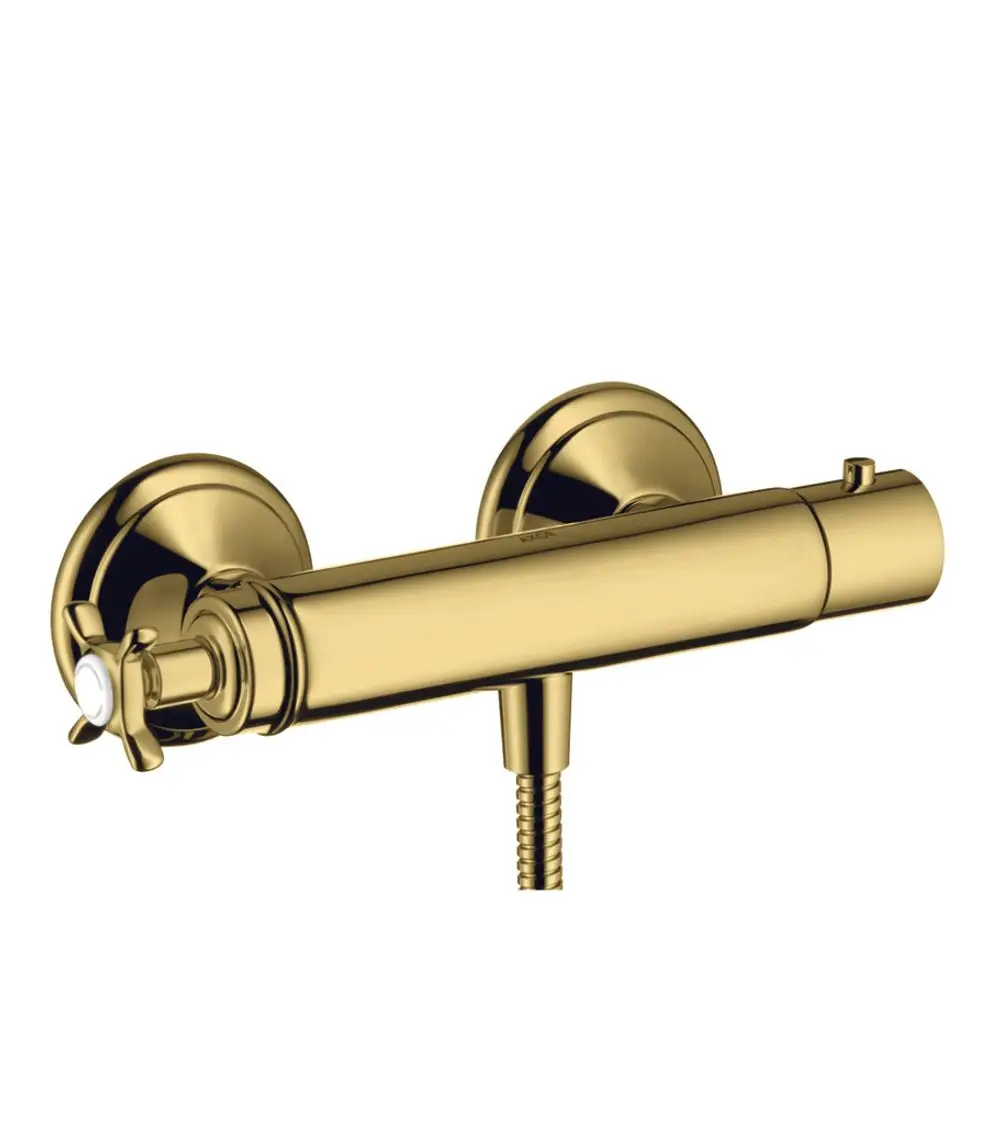 Brausethermostat in Polished Gold Optik, angebracht an der Wand. Mit einem Kreuzgriff zur Temperaturregelung. Produkt von AXOR.